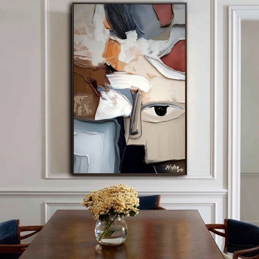 This original abstract face art adds a bold, modern contrast to the classic wainscoting and elegant molding of this traditional dining room.