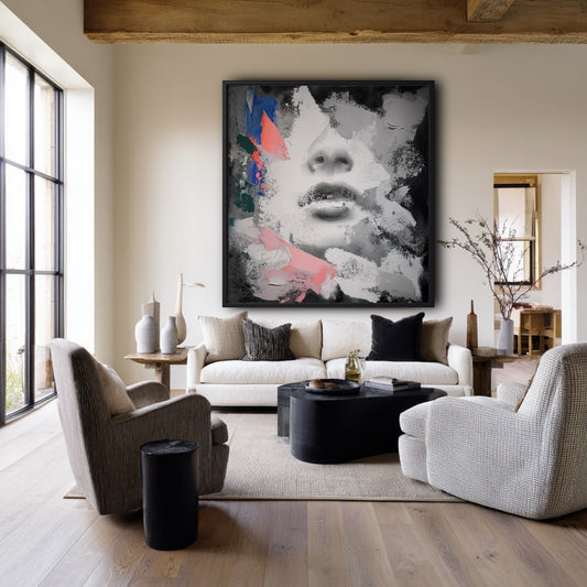Large abstract face art above a beige sofa in a rustic modern living room with exposed wood beams.
