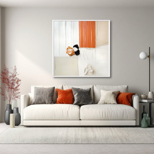 Warm abstract art over a white sofa, with vibrant orange and grey pillows that pull the painting's colors into the room for contrast.