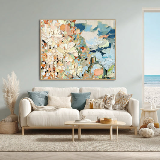 Colorful abstract art ties the cool blue wall and ocean view with warm florals, perfecting the tranquil coastal living room vibe.