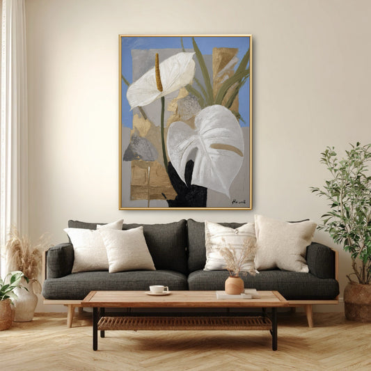 Blue and gold floral wall art styled over dark grey couch. Large vertical painting adding softness to modern masculine decor.