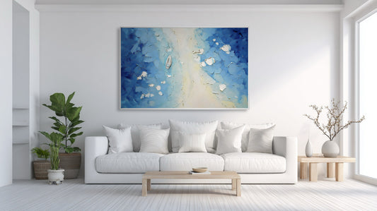 Original blue and white impasto art providing a refreshing color aura against a stark white wall in a bright, minimalist living space.