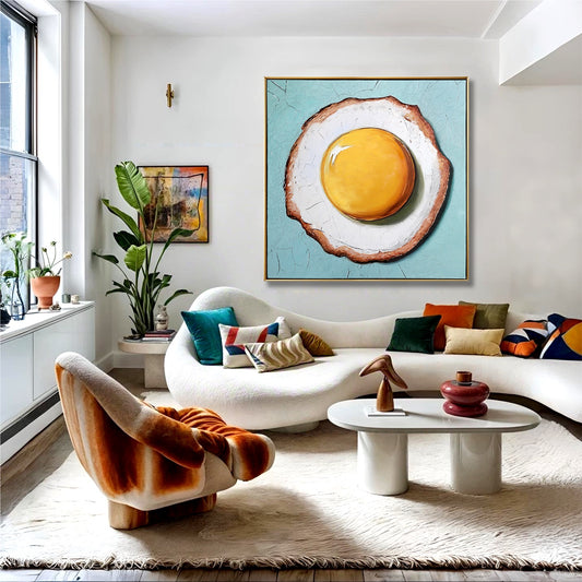 Oversized egg on toast painting in sunlit boho living room. Cool blue art balances warm velvet textures and curved white sofa.