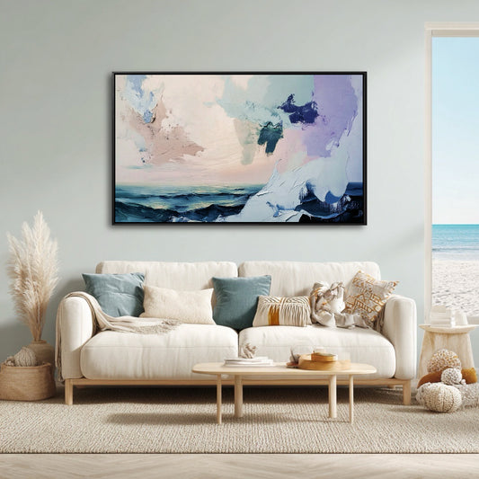 Coastal living room with a cream sofa and light blue walls, showing an abstract seascape that matches the beach view.