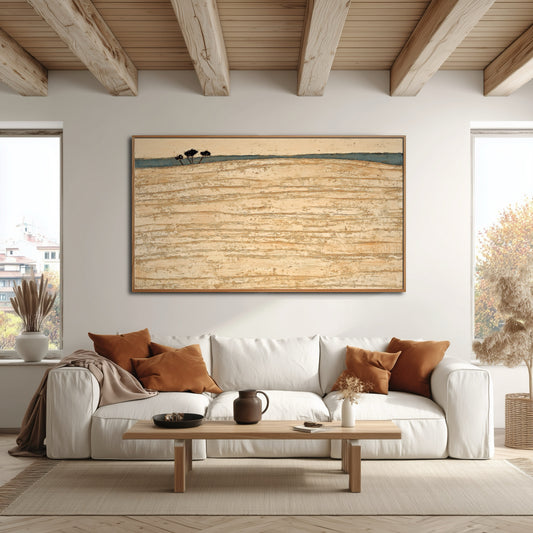 Gold-toned abstract art perfectly mirrors the warm wood ceiling beams and accent pillows over the white sofa in this bright, rustic space.