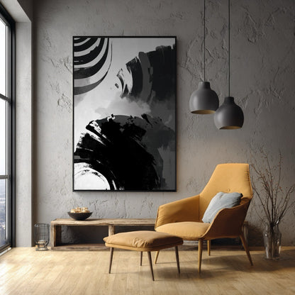 Vertical black and white abstract art on a concrete wall behind a mustard yellow armchair in a modern reading nook.