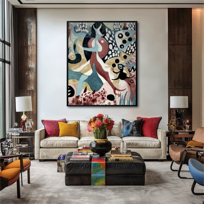 Large abstract painting hangs in a modern living room with colorful red, yellow, and blue pillows.