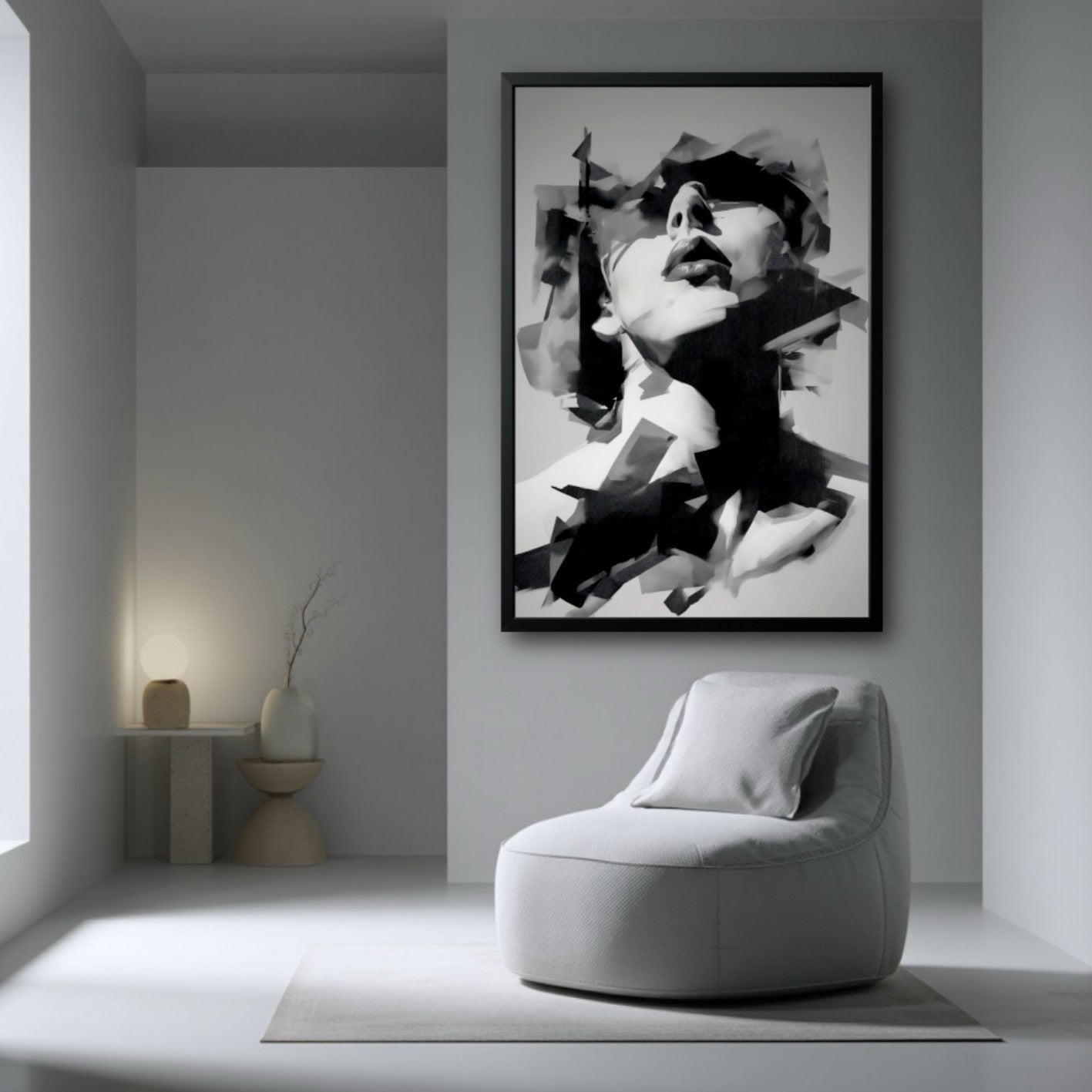 Large framed abstract portrait in a stark, minimalist white room with a single round, soft lounge chair.