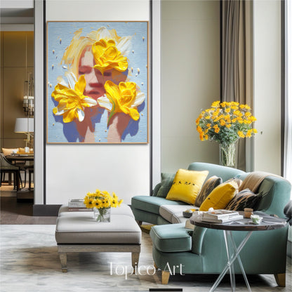 Expressive yellow flower art completes a stylish contemporary living space. The yellows in the painting coordinate with the throw pillows and fresh flowers above the teal sofa.