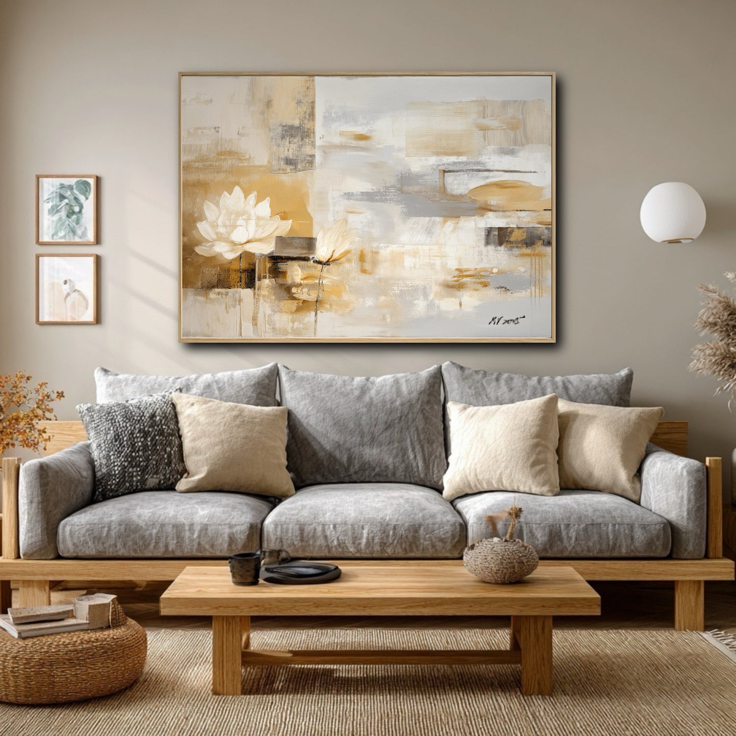 The abstract lotus painting's warm gold tones balance the cool grey sofa in this modern, neutral-toned Japandi living room.