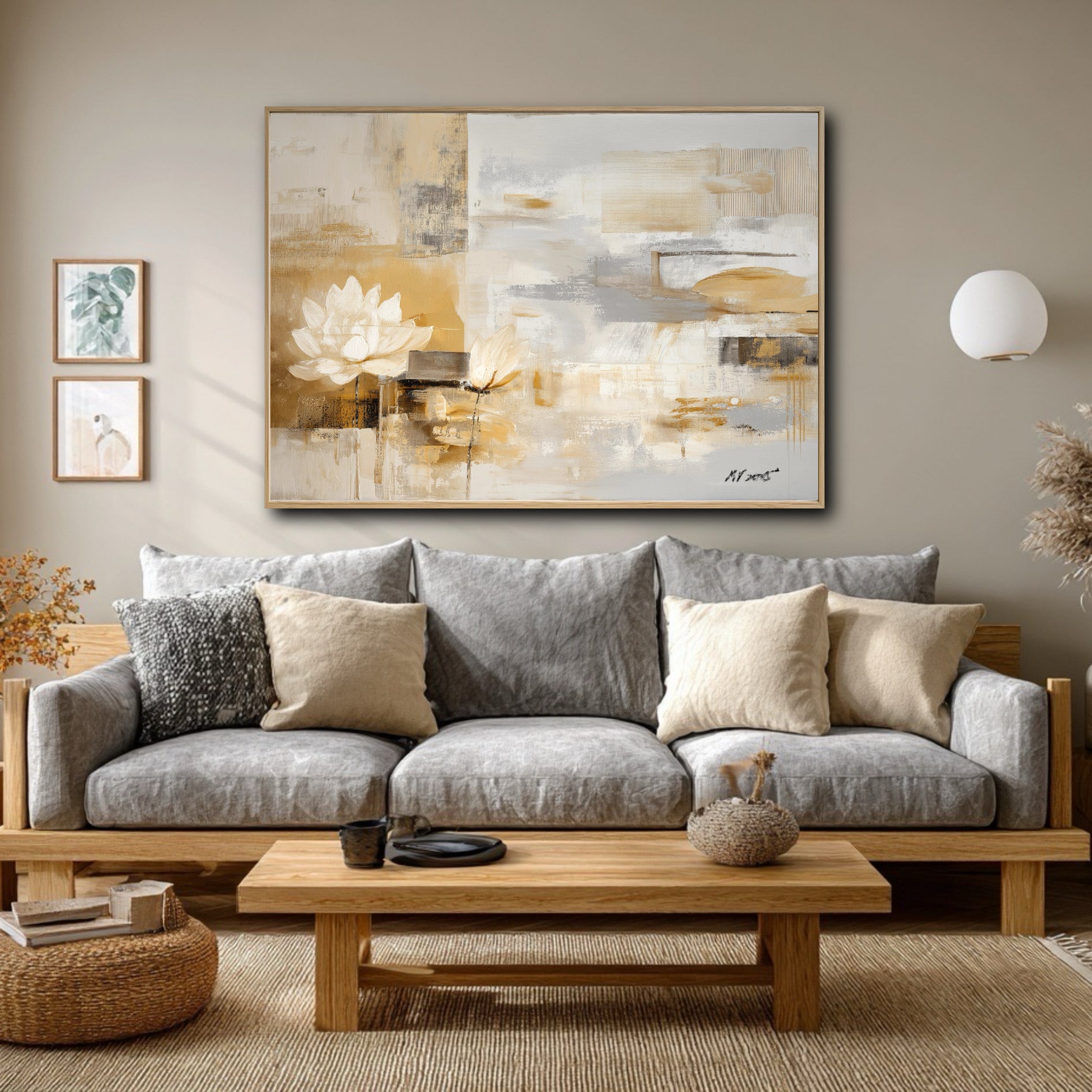 The abstract lotus painting's warm gold tones balance the cool grey sofa in this modern, neutral-toned Japandi living room.