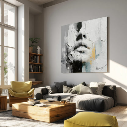 Large abstract face painting in a sunlit living room with a dark sofa, wooden coffee table, and yellow accent chairs.