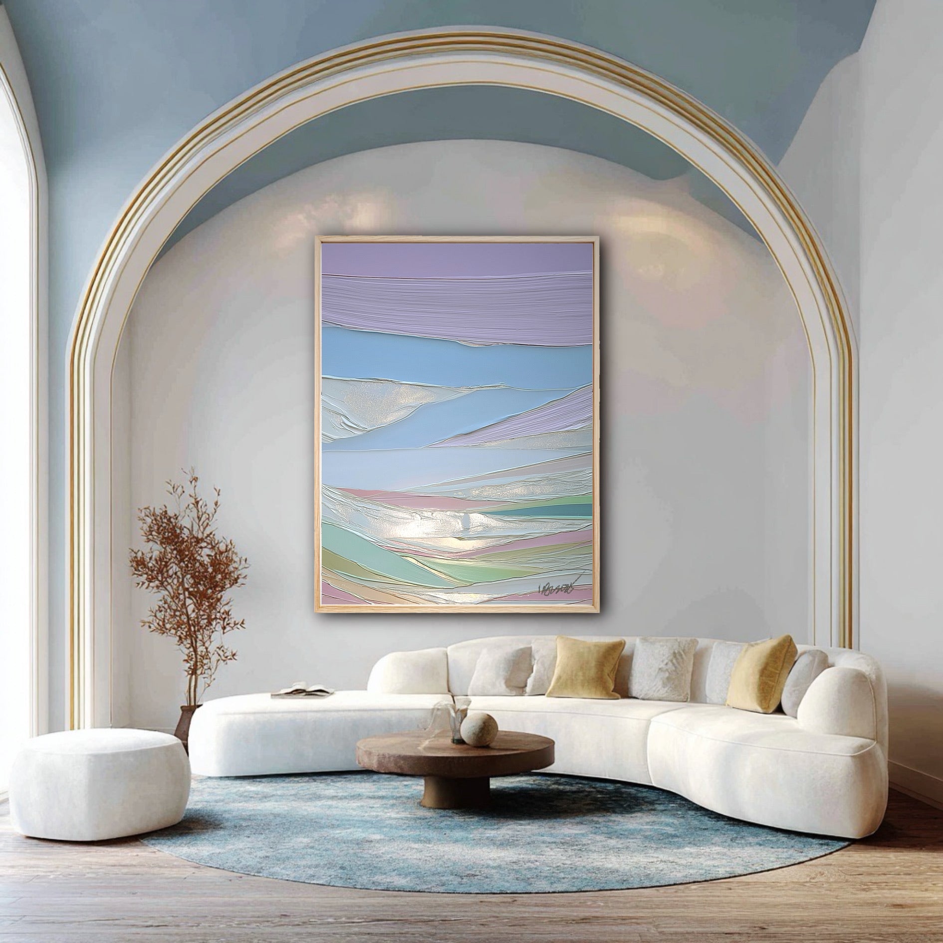 A vertical pastel abstract painting hangs under a large archway, complementing a modern white curved sofa and blue ceiling.