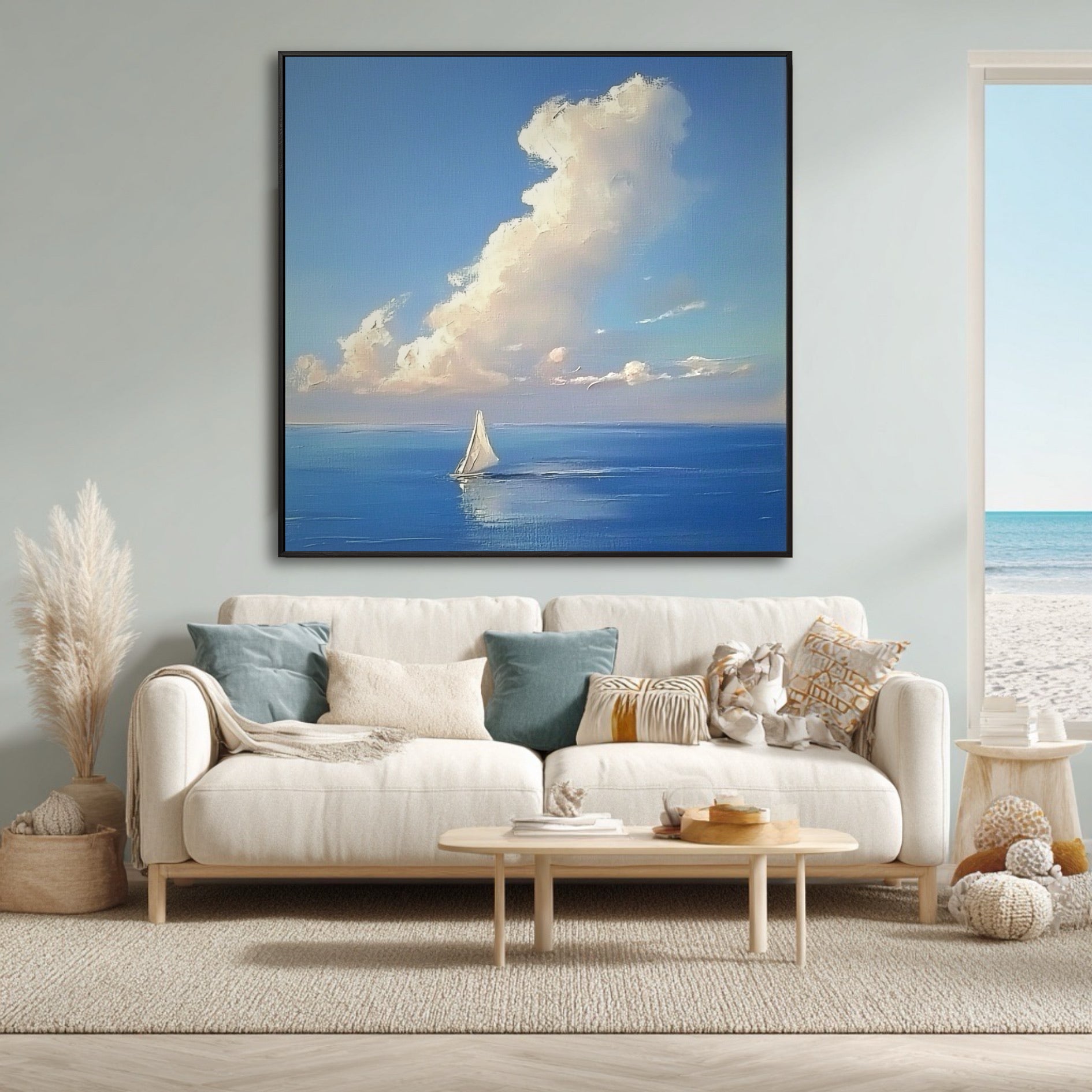 Airy coastal living room featuring a large seascape painting above a white sofa, with a window view of the beach.
