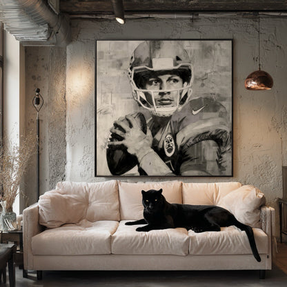 Framed quarterback portrait in an industrial loft with a pink sofa. A black panther is lying on the sofa.
