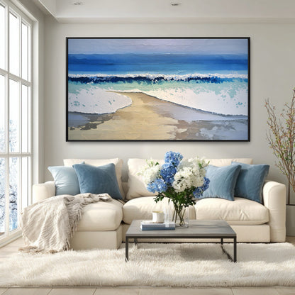 A large coastal painting's blue ocean tones perfectly coordinate with the accent pillows on a white sectional in a bright, modern room.
