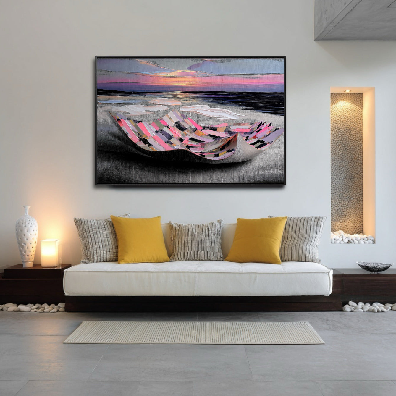 Colorful abstract painting above a low, white sofa in a minimalist room with warm ambient lighting and decorative pebbles.