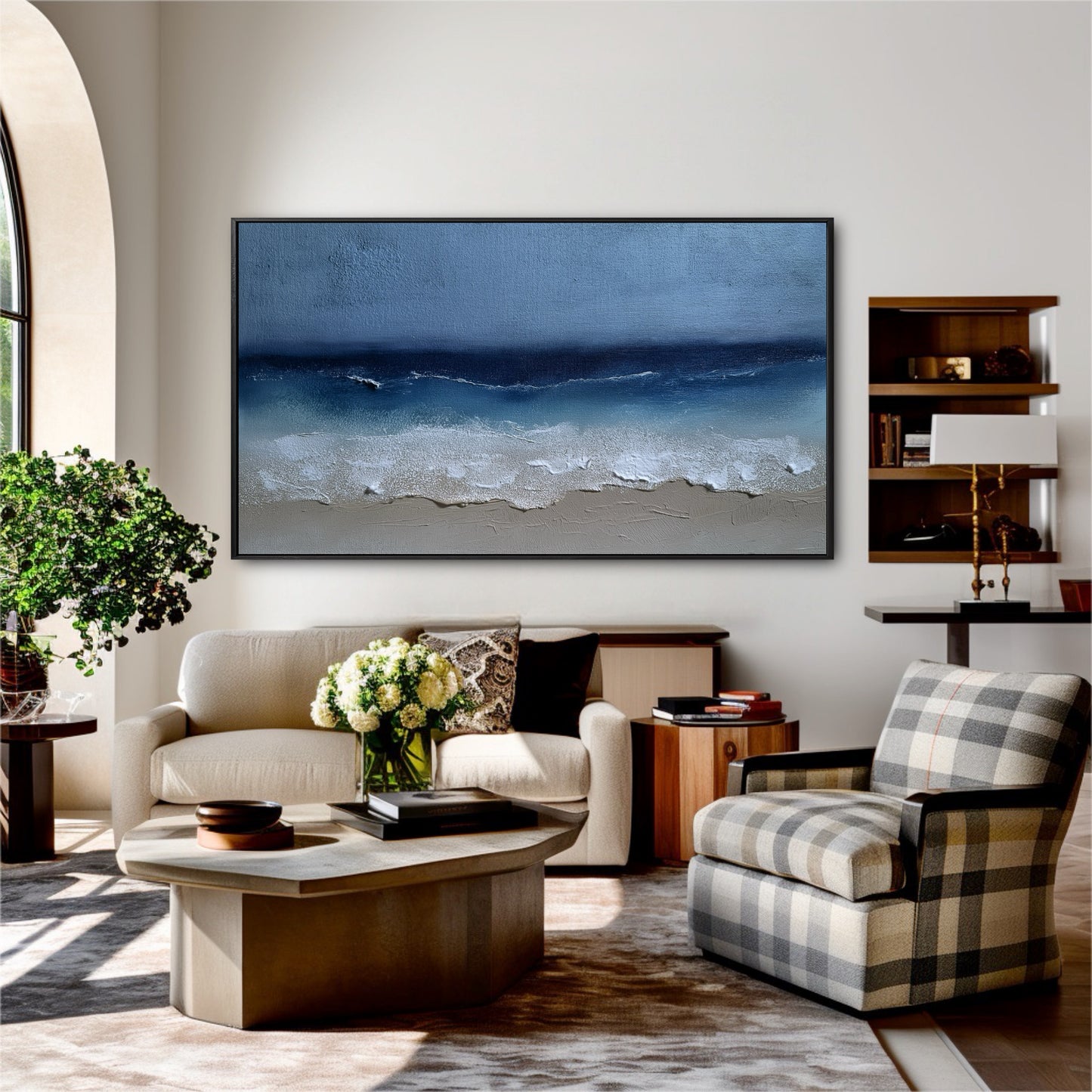 The abstract ocean painting's rich impasto texture provides a natural, calming balance to the plaid chair and wood furniture in this warm room.