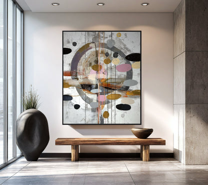 Large original abstract art anchors a neutral foyer with a concrete wall, stone floor, and long wood bench.