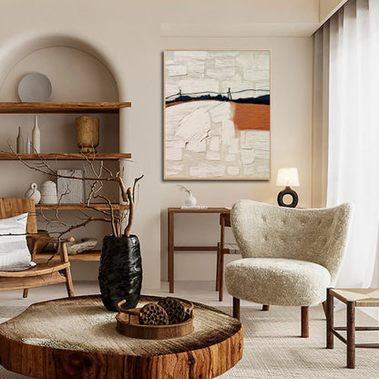 Earth-toned abstract art’s texture complements the raw wood coffee table and sherpa chair in this eclectic, organic living space.