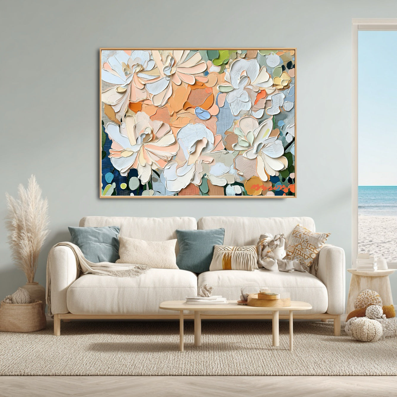 Abstract floral art perfectly ties the interior's blue and peach palette to the serene coastal view and natural rattan elements.