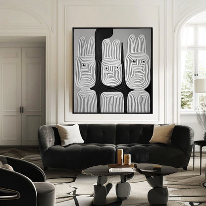 Black and white textured rabbit art hangs over a plush black velvet sofa in an elegant, classic living room with arched details.