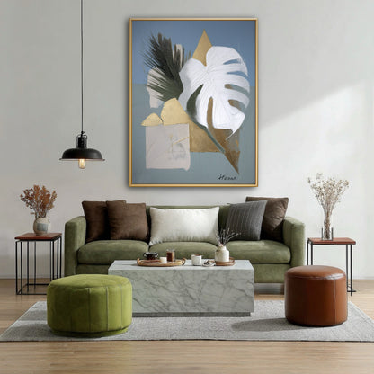 Gold and white leaf painting in a contemporary living room. Metallic accents pop against the deep green velvet sofa and marble.