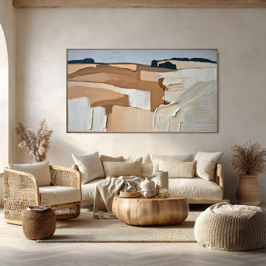 Textured abstract landscape is a visual extension of the rattan, wood, and natural textiles in this cohesive Bohemian room.