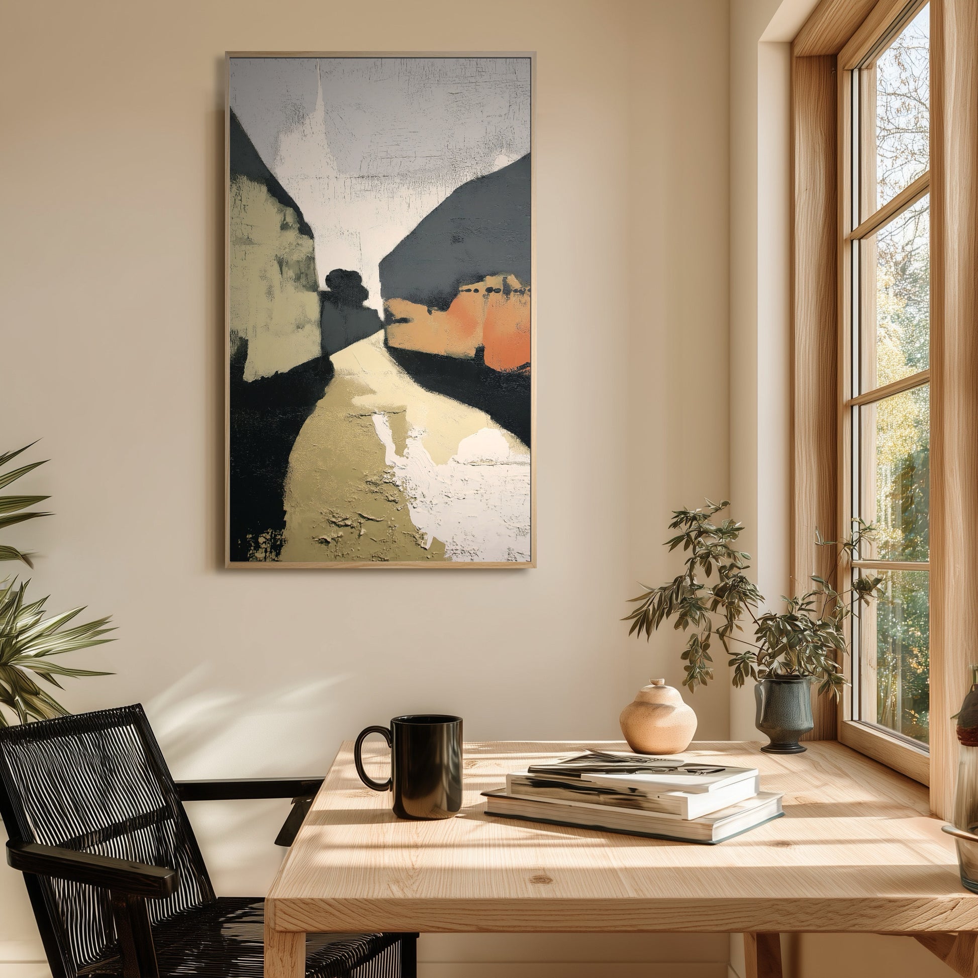 Dark abstract geometric art grounds the bright natural light and light wood tones of the window-side home office setup.