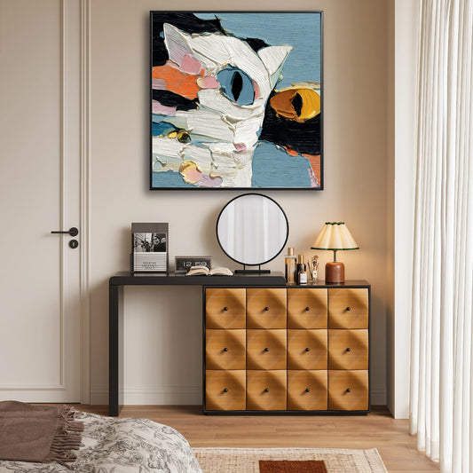 Textured cat portrait brightening a warm dresser and entryway, providing a colorful, artistic focal point against the beige wall.