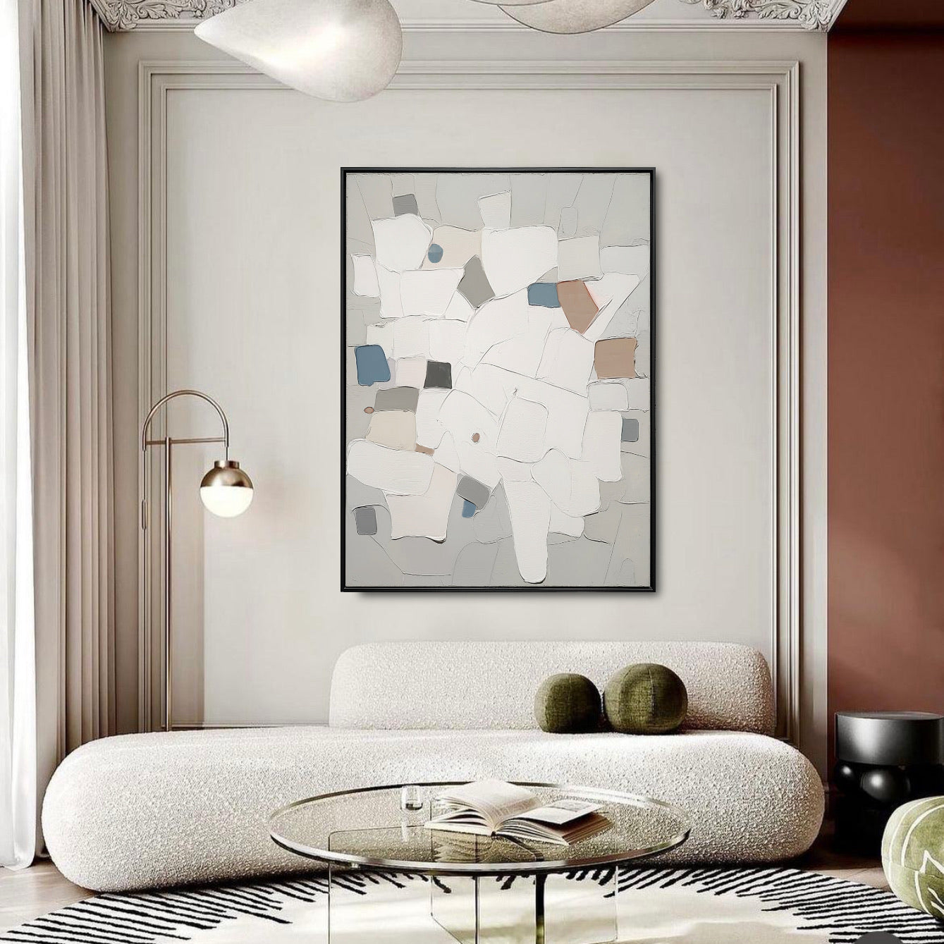 Modern living room with abstract art, white sofa, and glass coffee table.