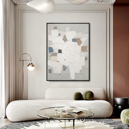 Modern living room with abstract art, white sofa, and glass coffee table.