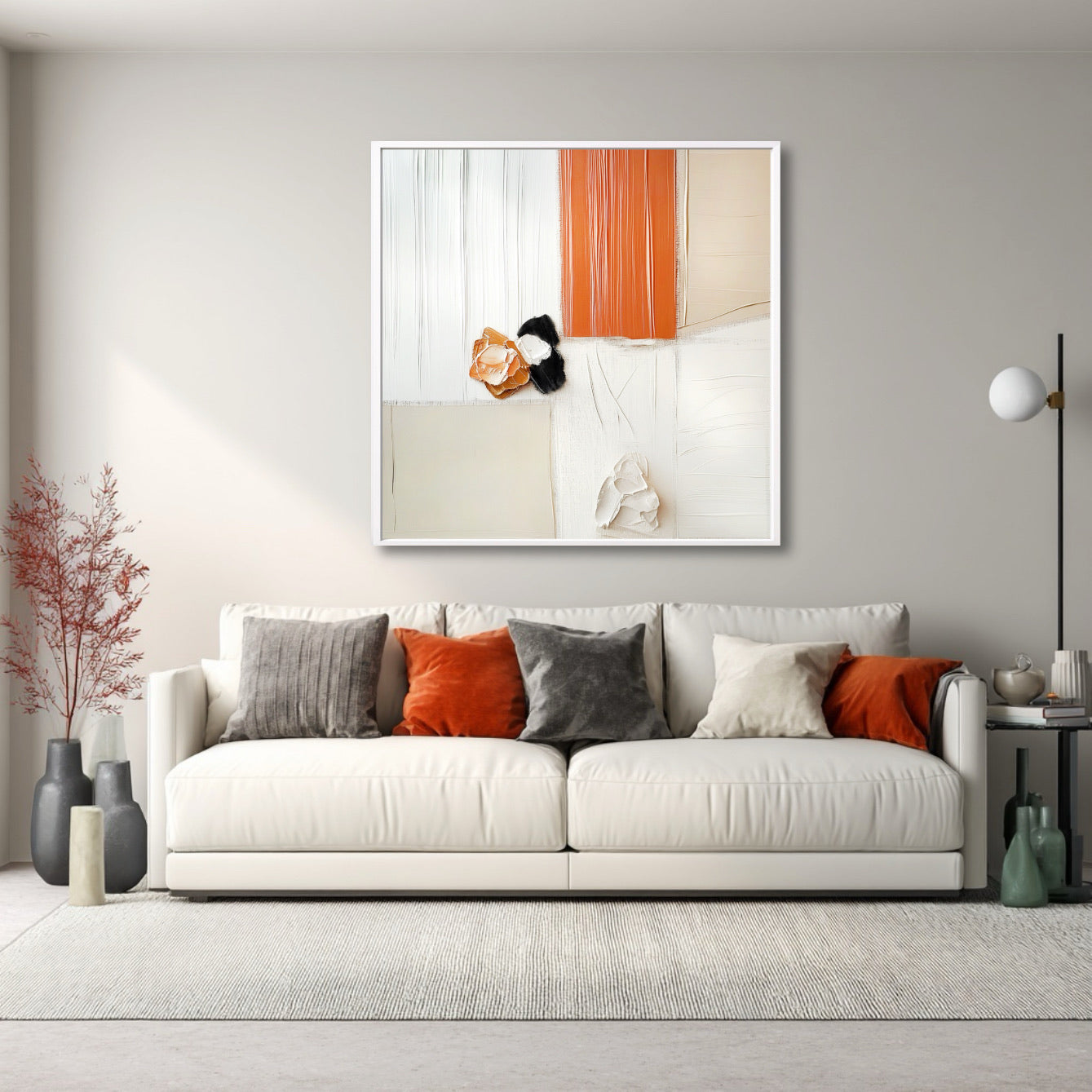 Warm abstract art over a white sofa, with vibrant orange and grey pillows that pull the painting's colors into the room for contrast.