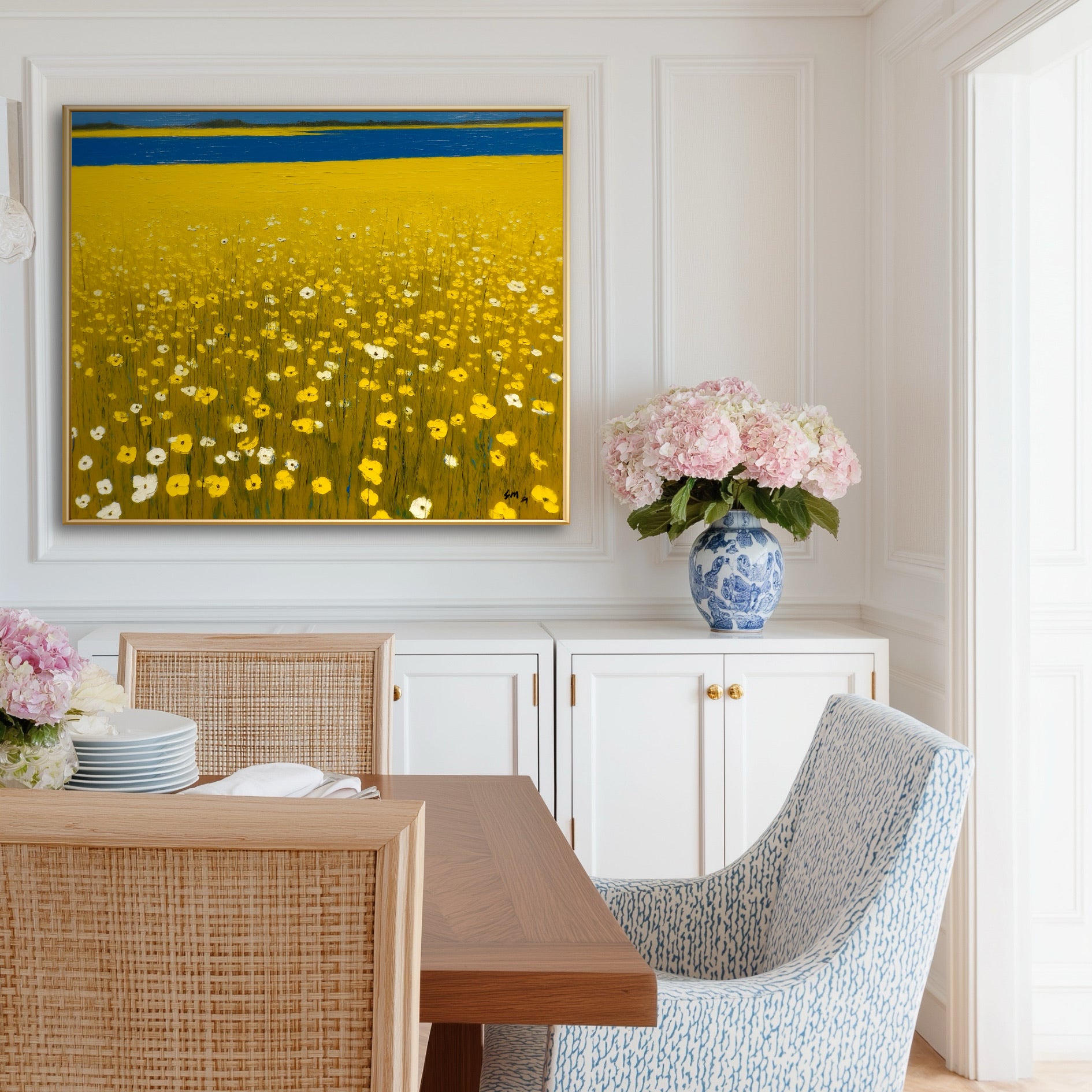 Elegant & Coastal Original yellow floral painting in an elegant dining room. Blue accents and pink hydrangeas complement the bright coastal art.
