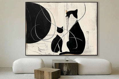 Textured cat art balances the natural wood and low-profile white furniture, adding strong black contrast to a minimalist lounge.