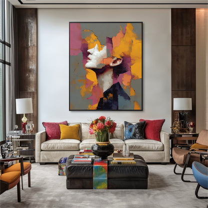 Large abstract sunset portrait brightens a luxury neutral living room. The art provides a bold color contrast against the textured walls and light upholstery.
