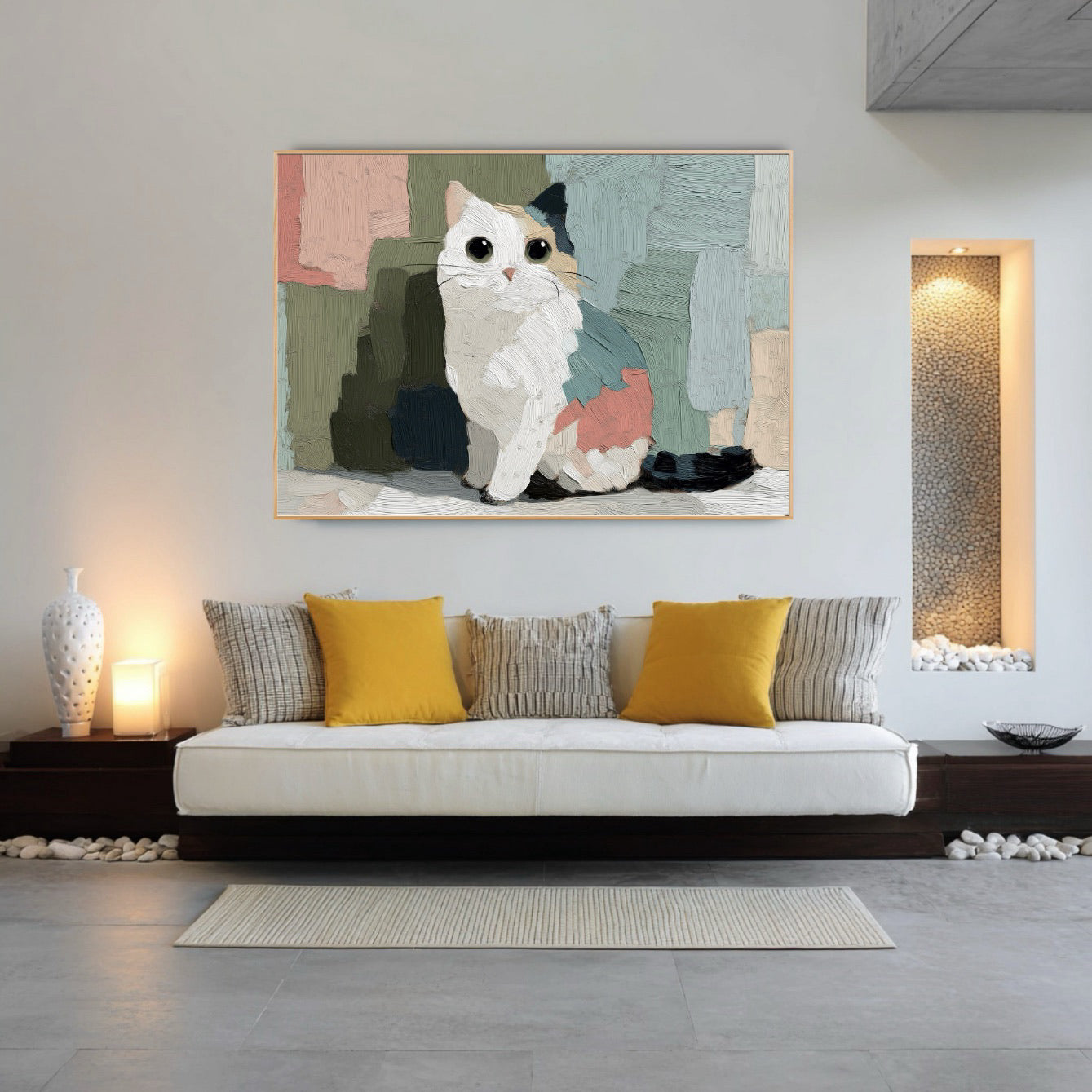 Cat portrait art brightens a minimalist, spa-like lounge with a low platform sofa, yellow accent pillows, and decorative stone-filled niches with ambient lighting.