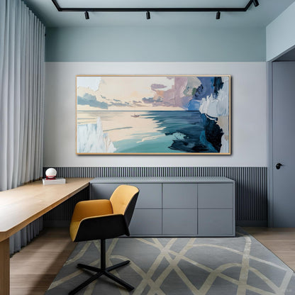 Modern home office with a yellow chair and grey cabinets, displaying a large abstract ocean painting on a two-tone wall.