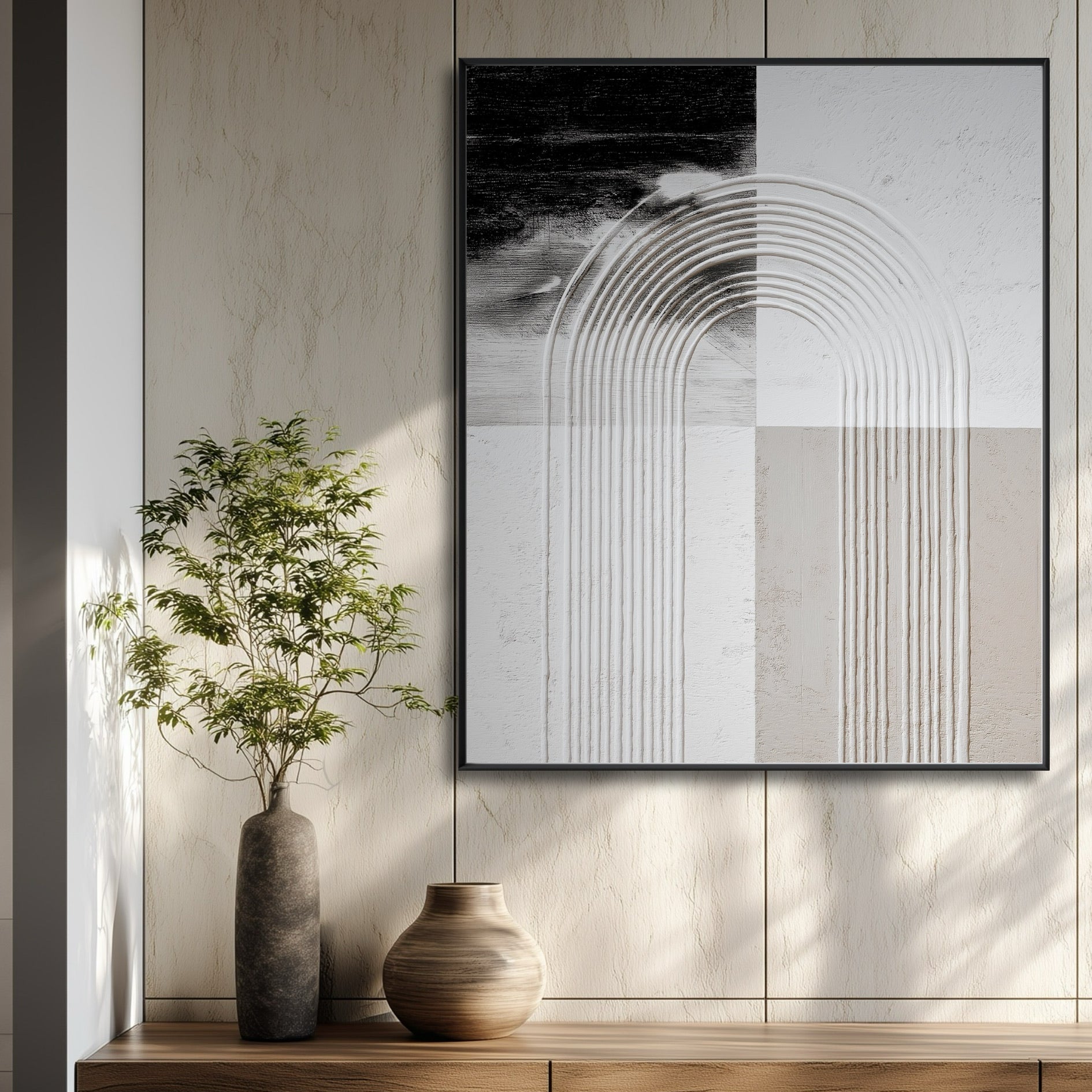 Geometric abstract art in a black frame hangs on a paneled wall in a modern entryway above a wood console table.