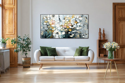 Original abstract floral art above minimalist white sofa, blending cool tones with warm wood and vivid green pillows.