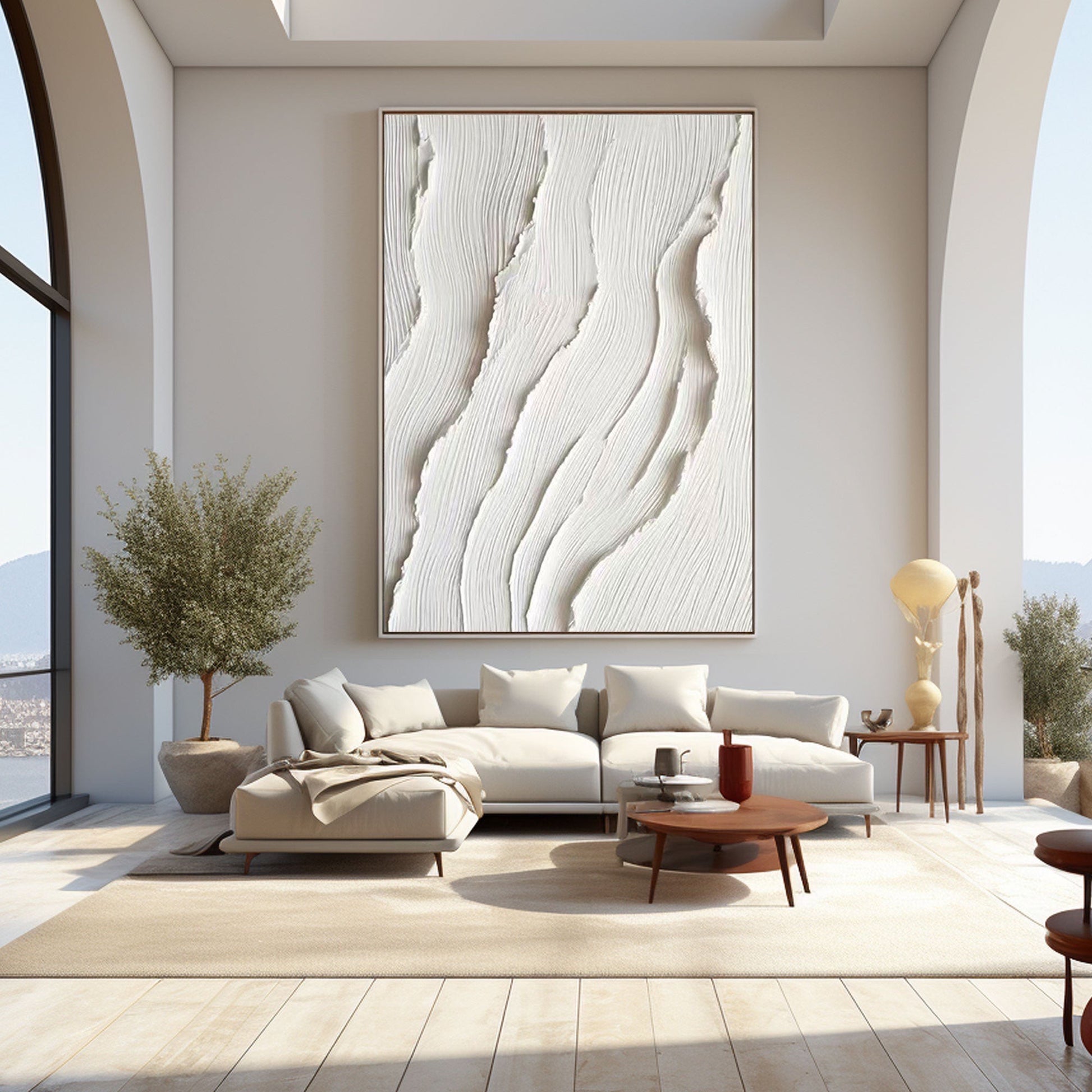 Original art as a large-scale feature in an expansive living room with arched windows and a white sectional sofa.