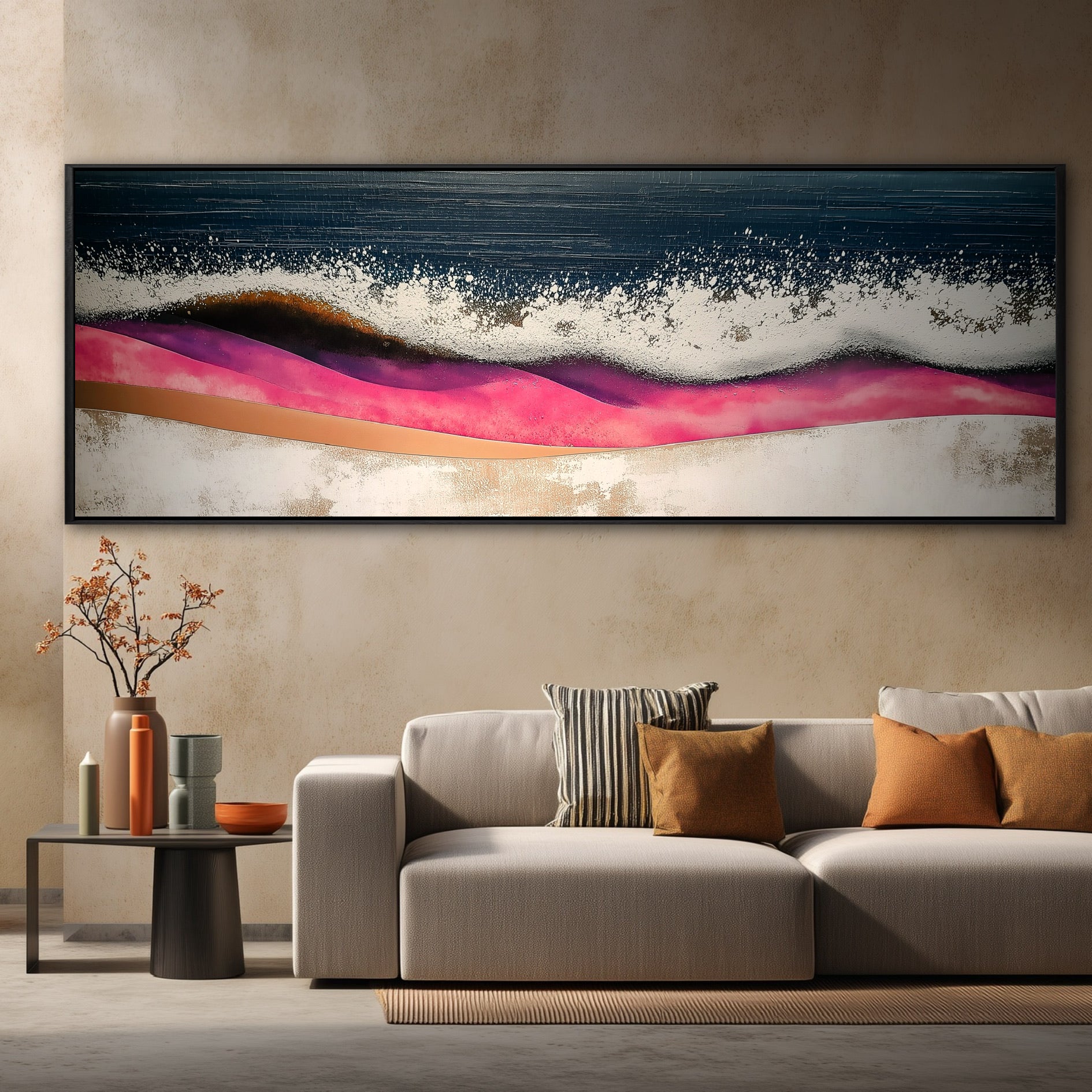 An original abstract ocean painting with pink hills hangs over a beige sofa against a warm, textured beige wall.