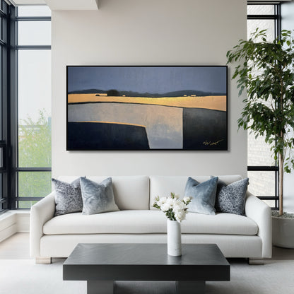 Large blue and gold painting above a white sofa with plush pillows in a sleek, window-lined contemporary room.