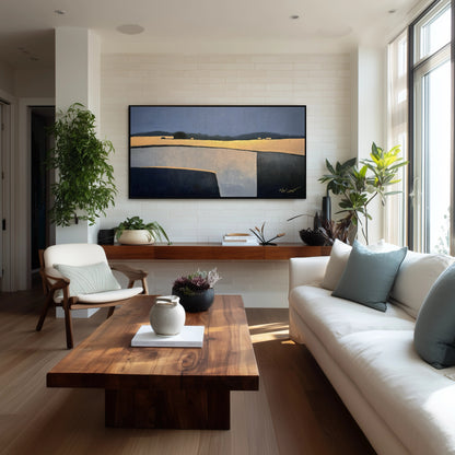 Original landscape art on white brick wall, enhancing the warm wood tones and lush plants in a bright living space.