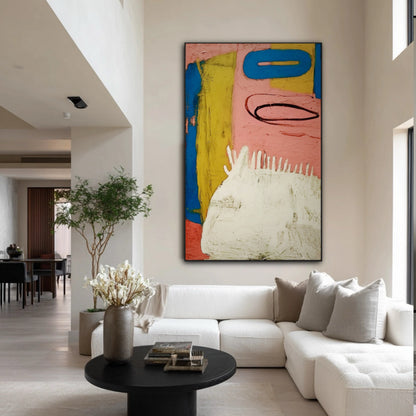Large abstract art brightens a high-ceiling living space with a textured white sectional and black coffee table, offering a modern focal point.