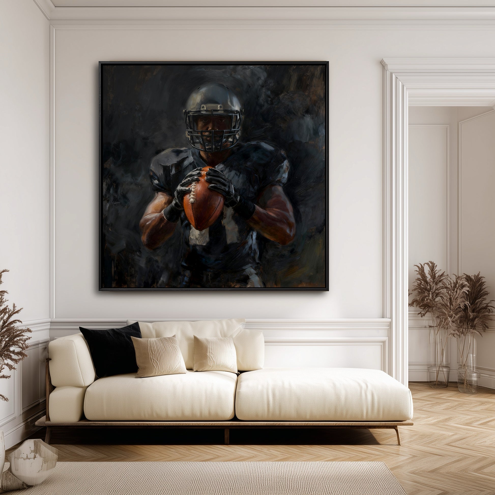 Large painting of a football player in a modern minimalist living room with white walls and a cream-colored low-profile sofa.