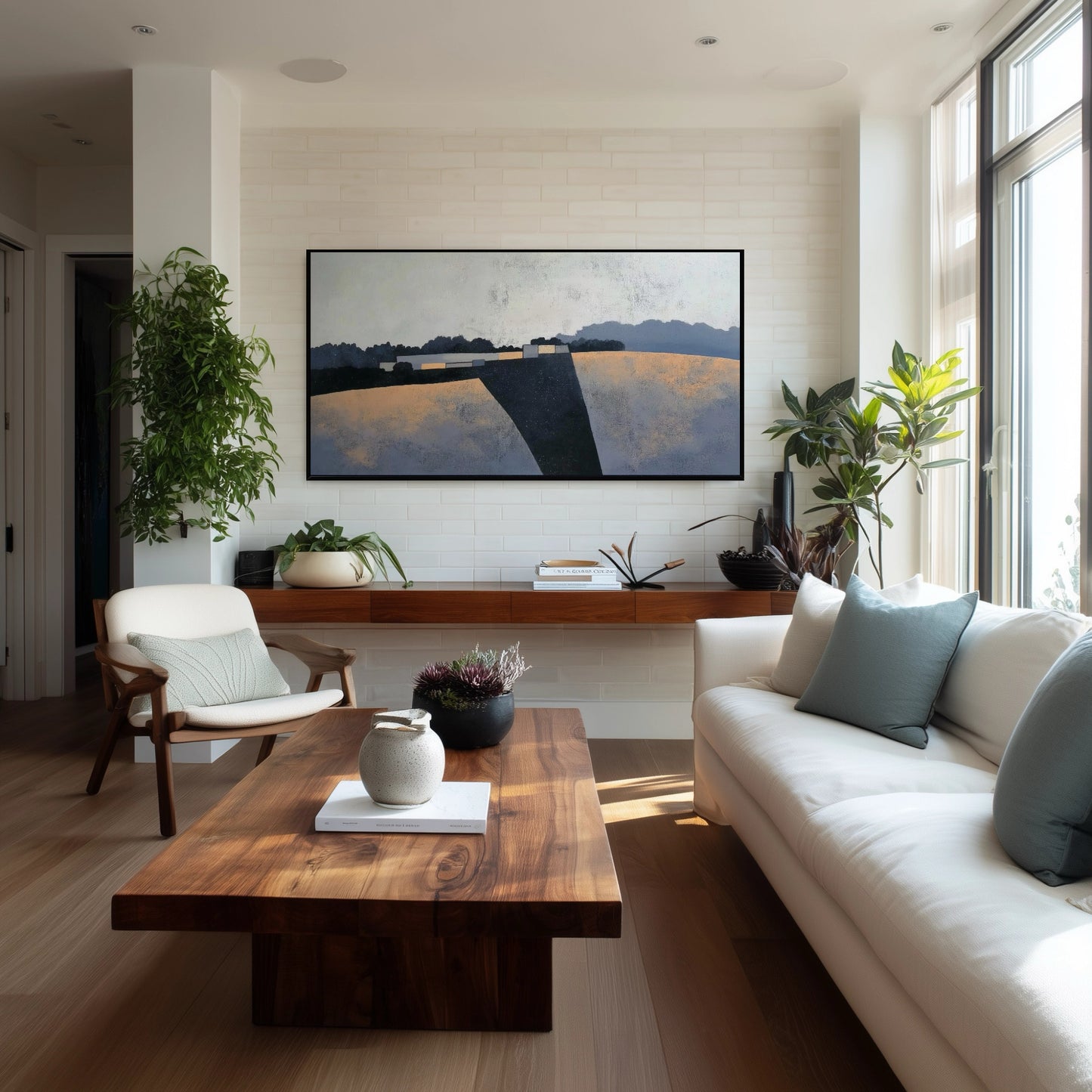 Original abstract landscape painting creating a sophisticated focal point above a wood console table in a bright, bohemian-style living space.