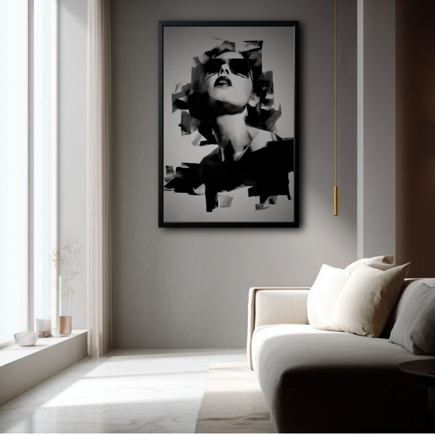Large framed black and white portrait in a bright, modern living room with a beige sofa and a tall, narrow window.