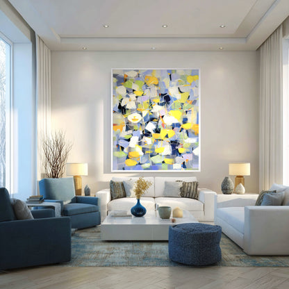Abstract Expressionist art hangs in a contemporary living room, harmonizing with the cool blue armchairs and white sectional seating.