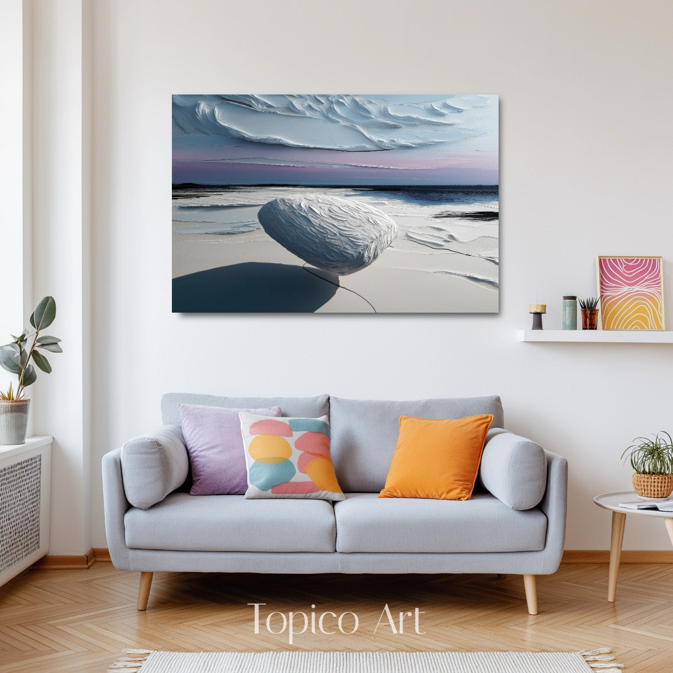 Abstract stone art complementing a warm neutral living room with velvet purple cushions and chic, curved armchairs.
